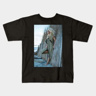 Sexy woman in cardigan on the sea shore Kids T-Shirt
